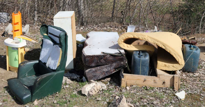A large pile of old furniture and other junk in the yard