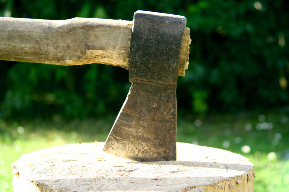 An axe head in a block of wood