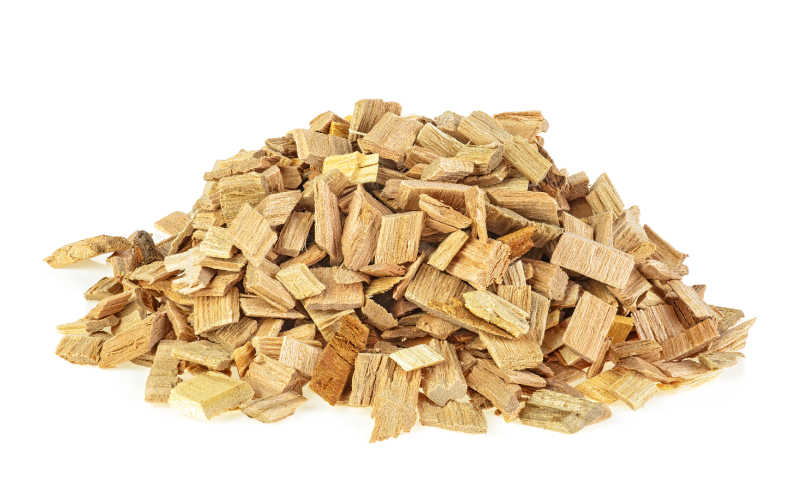 Hickory wood chips in a small pile on white background