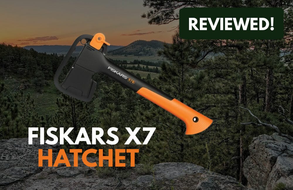 Fiskars X7 Hatchet with trees in the background