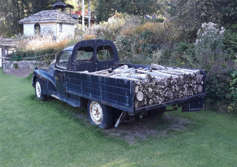 A black pickup truck filled with firewood