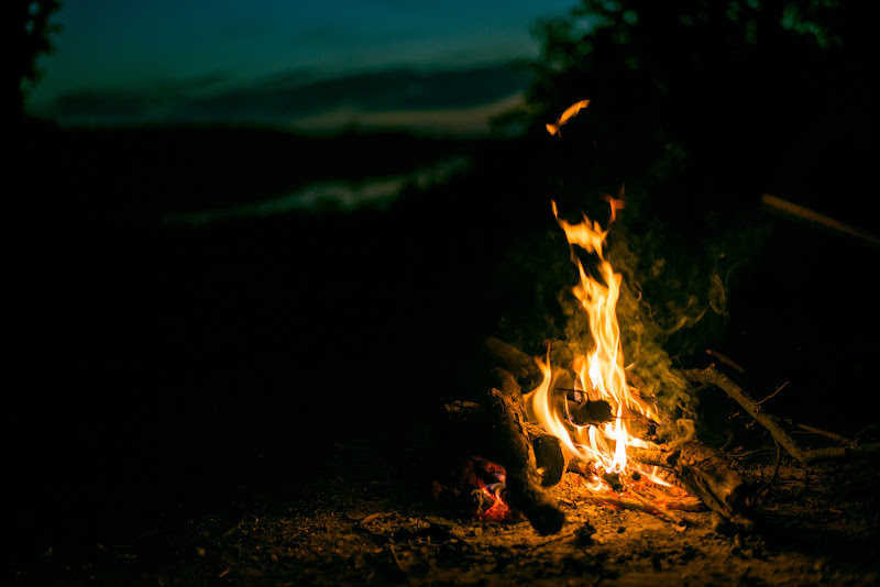 A roaring campfire late at night