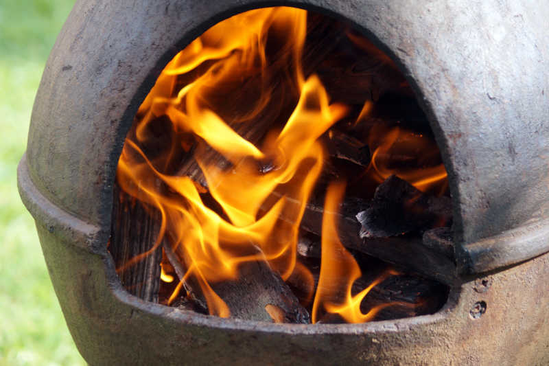 Closeup of burning pinyon pine firewood in a chiminea