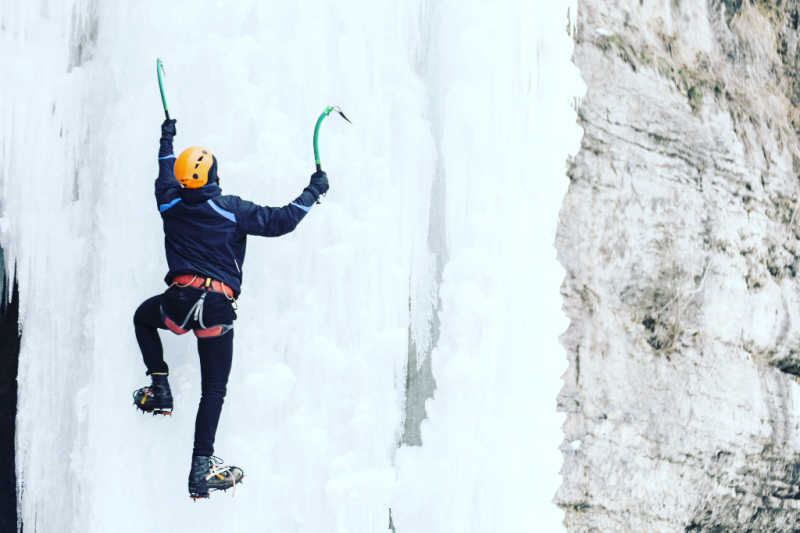 Climbing a frozen waterfall with two ice tools