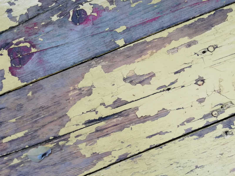 Old timber with yellow paint peeling off