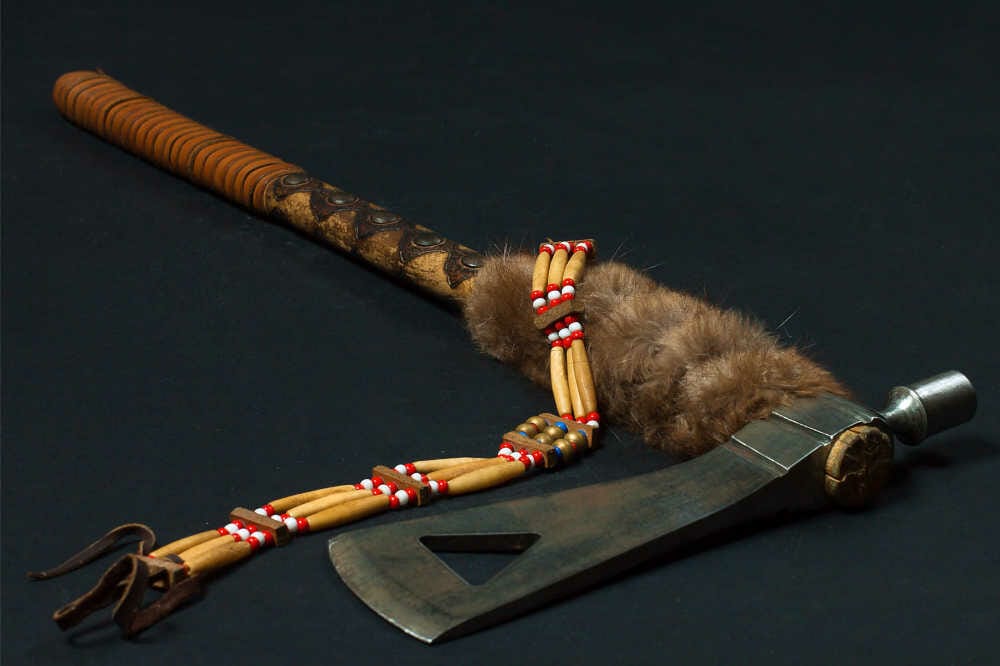 A traditional tomahawk on a black surface