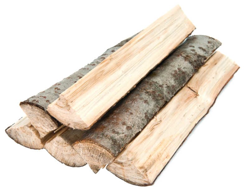 A small stack of split aspen firewood on a white background 